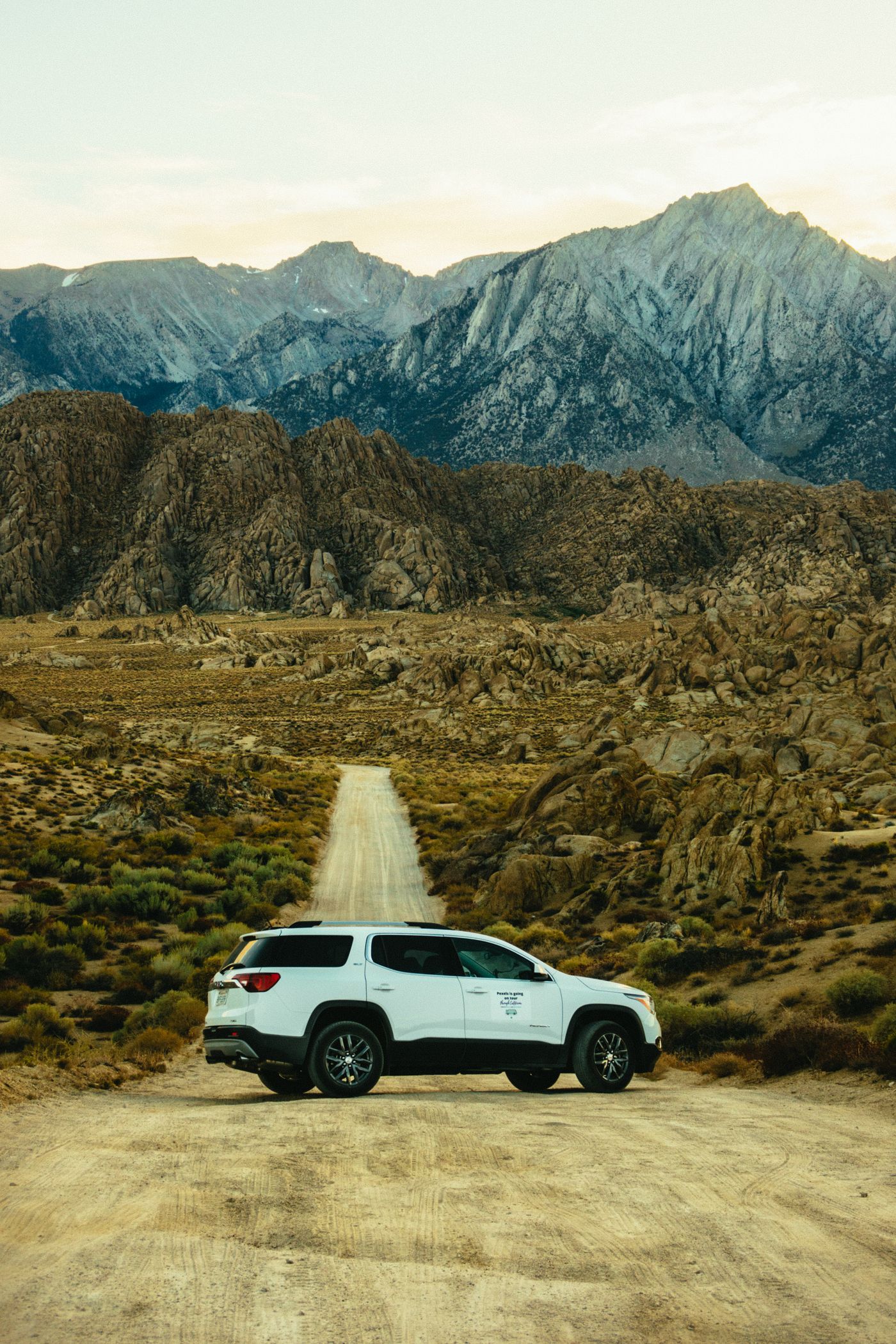White SUV on a scenic open road
